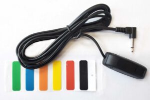 A black plastic switch, cable, and multi-colore stickers