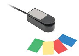 A small plastic switch with green, yellow, red, and blue stickers