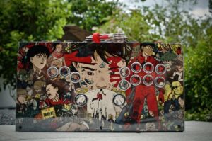A flat box with buttons decorated in anime style with trees in the background